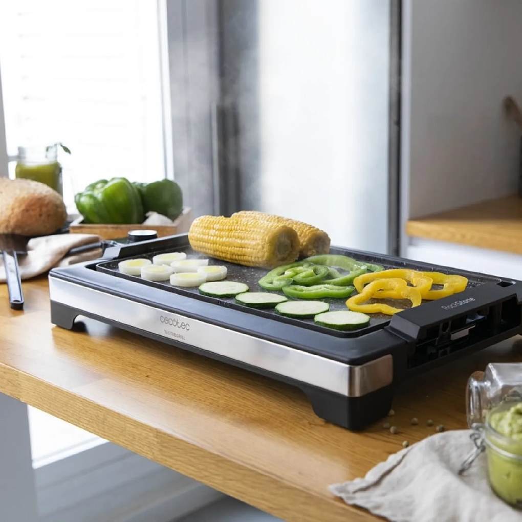 Grelhador elétrico Tasty&amp;Grill 2000 InoxStone de 2000 W, com estrutura de design e acabamentos em aço inoxidável. Termostato regulável e placa antiade