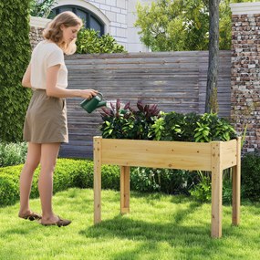 Floreira jardim elevada para plantas em madeira com orifícios de drenagem e espaços para frutas, legumes e ervas aromáticas natural
